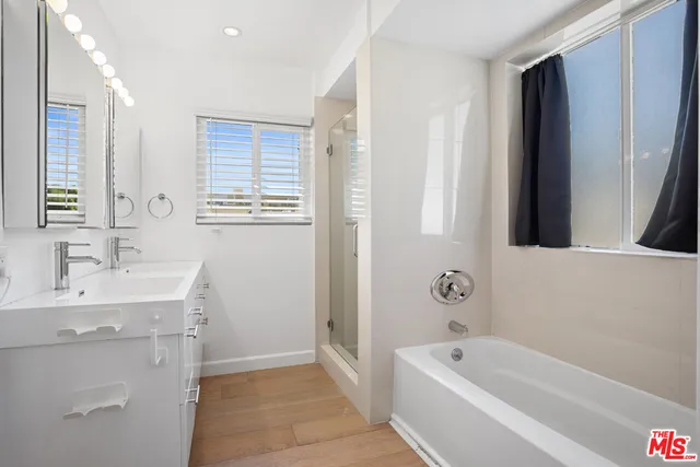 a bathroom with a tub sink and mirror