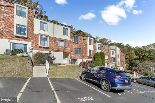a front view of a residential apartment building with a yard