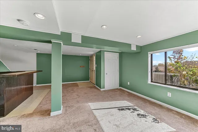 a view of hallway with a large window and chandelier