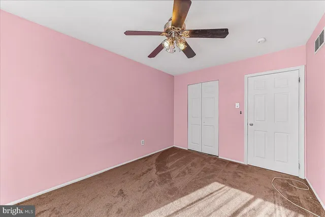 a front view of a residential apartment building with a yard