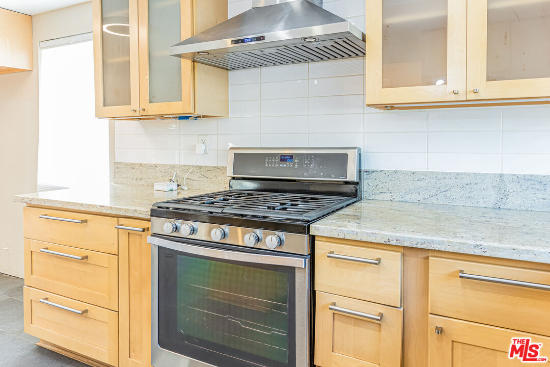 2 Tortoise Shell Irvine, CA 92604 - Photo 16 of 27 a kitchen with granite countertop cabinets stainless steel appliances and wooden floor