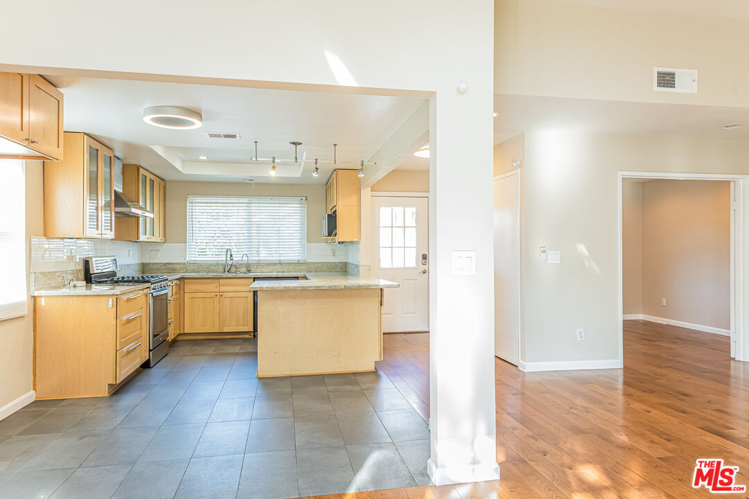 2 Tortoise Shell Irvine, CA 92604 - Photo 18 of 27 a large kitchen with a lot of counter space and wooden floor