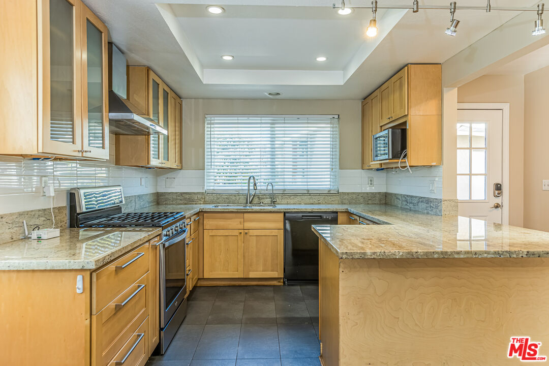 2 Tortoise Shell Irvine, CA 92604 - Photo 4 of 27 a kitchen with stainless steel appliances granite countertop a sink stove and cabinets