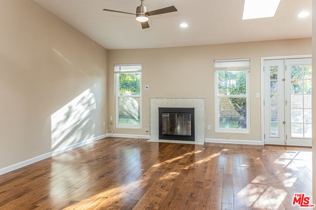 2 Tortoise Shell Irvine, CA 92604 - Photo 6 of 27 a view of an empty room with wooden floor and a window