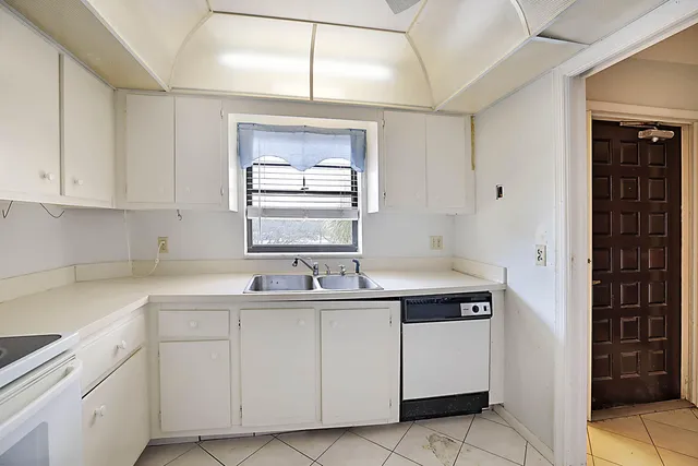 a kitchen with a sink cabinets and window