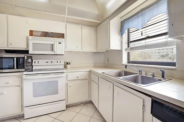 a kitchen with appliances cabinets and a sink