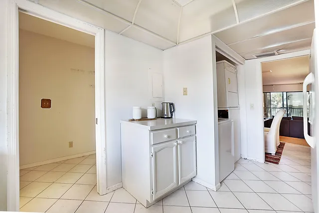 a kitchen with white cabinets and sink