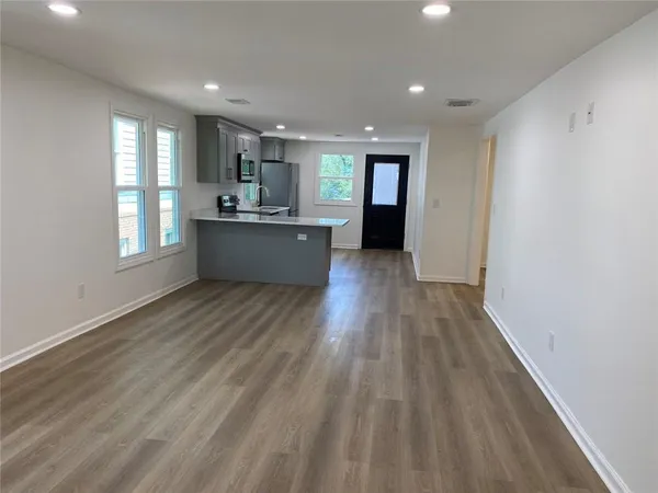 a view of a hallway with wooden floor