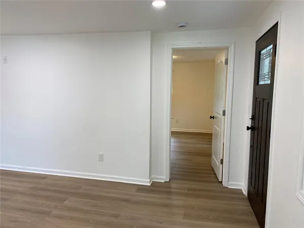 an empty room with wooden floor and closet