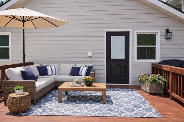 a living room with furniture and a potted plant