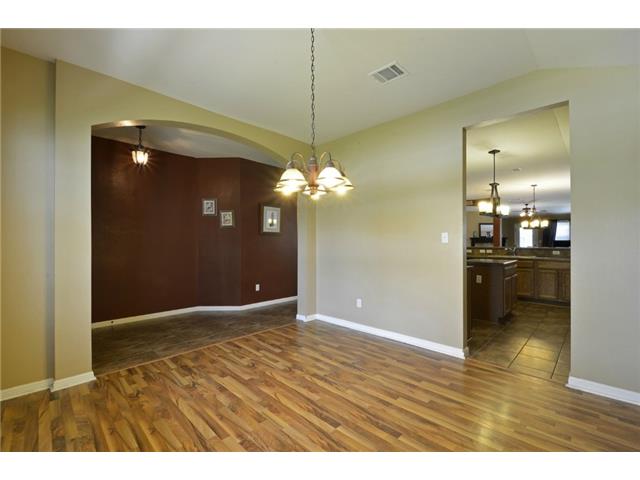 11612 Timber Heights Drive Austin, TX 78754 - Photo 28 of 28 An inviting open floorplan seamlessly connects the dining area to the kitchen and an adjacent room.
