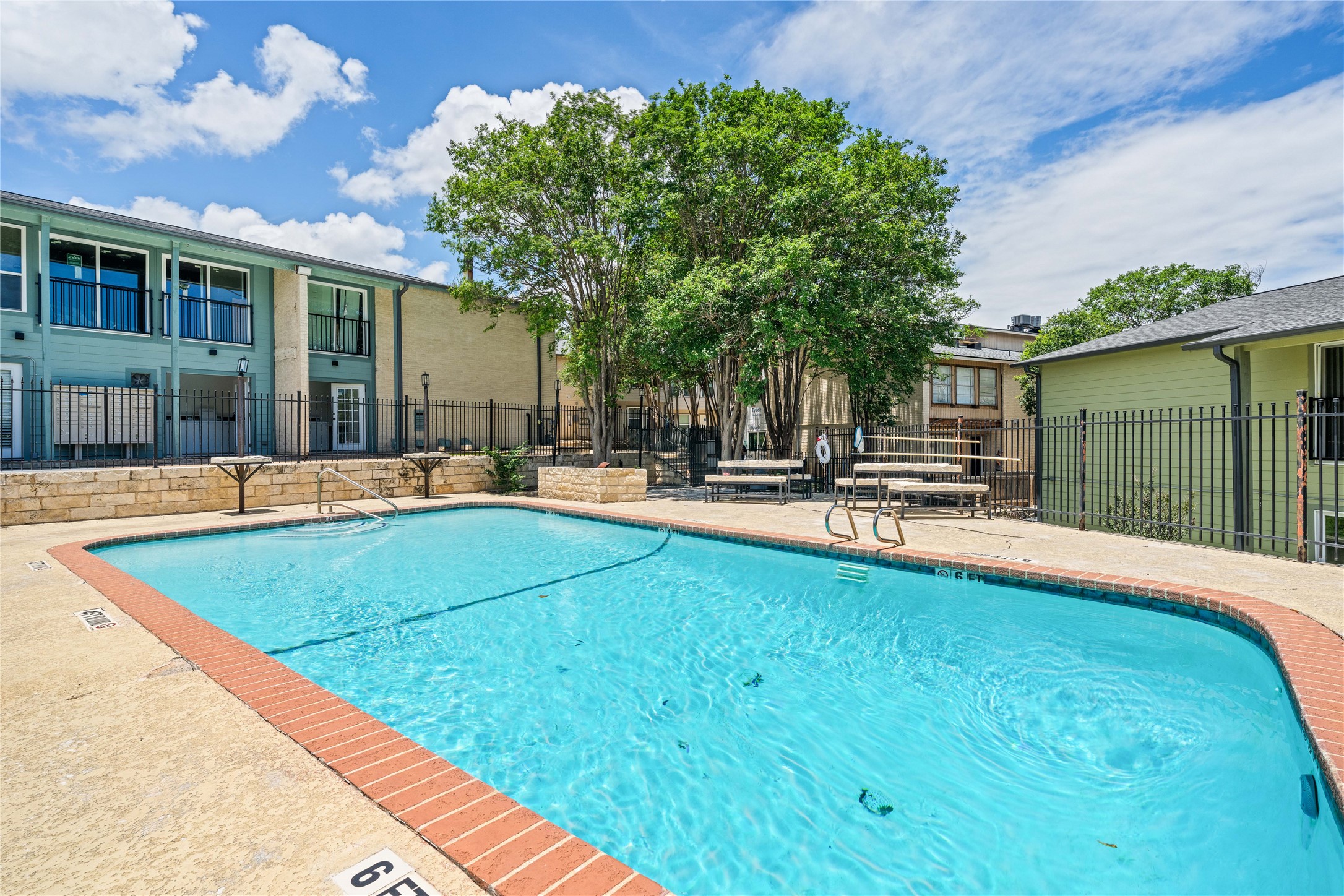 2124 Burton Drive, Unit 159 Austin, TX 78741 - Photo 1 of 23 A refreshing pool awaits, nestled amidst well-maintained apartment buildings.