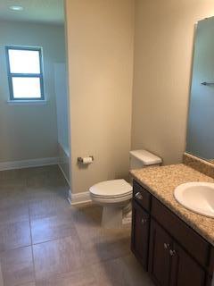 5760 Marigold Loop Crestview, FL 32539 - Photo 29 of 31 a bathroom with a granite countertop toilet and a sink
