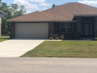 5760 Marigold Loop Crestview, FL 32539 - Photo 3 of 31 a front view of a house with garden