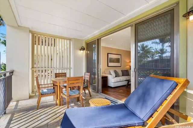 a dining room with wooden floor a chandelier a wooden table and chairs