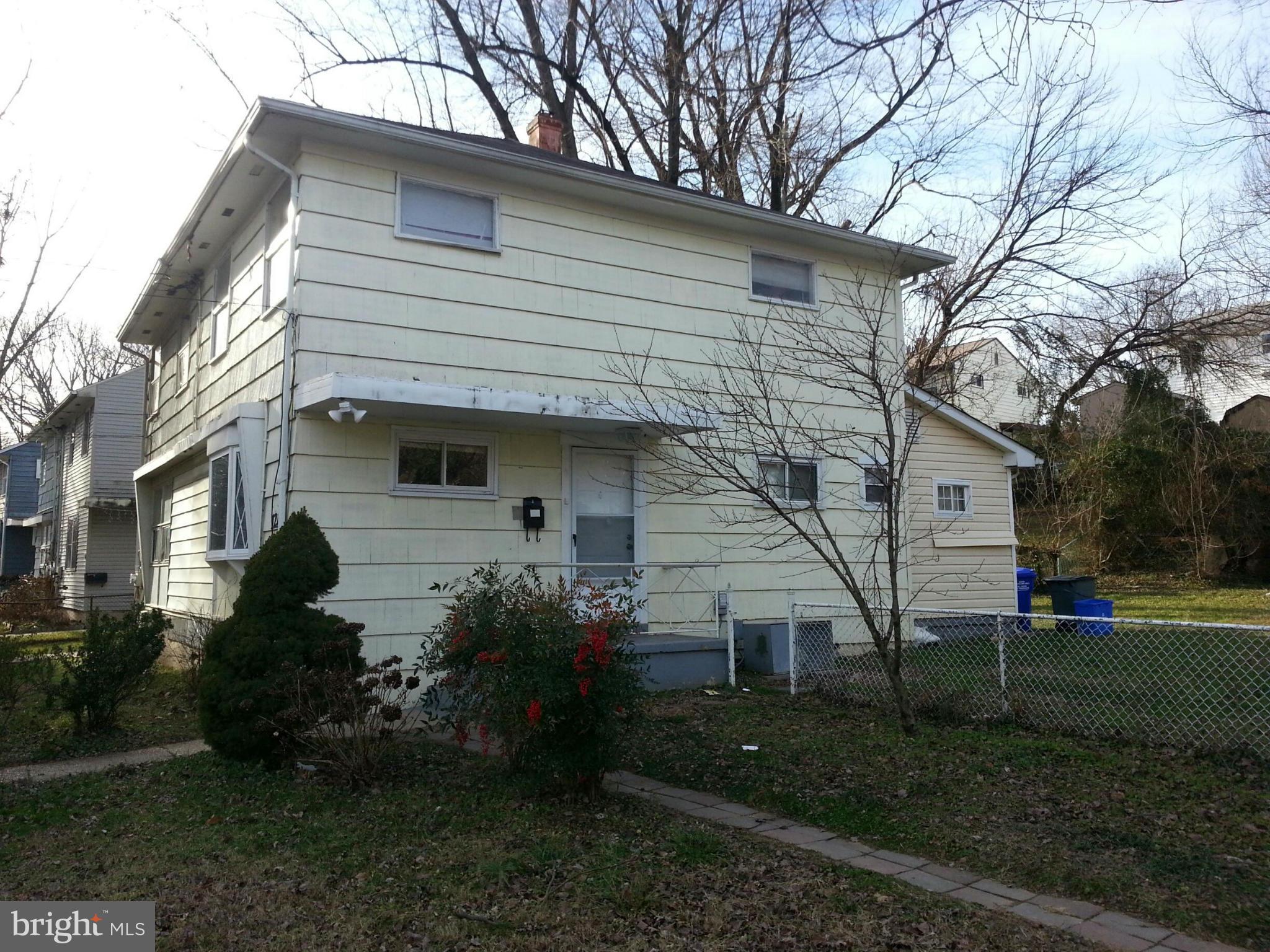 12130 Bluhill Road Silver Spring, MD 20902 - Photo 1 of 6 a front view of a house with a garden