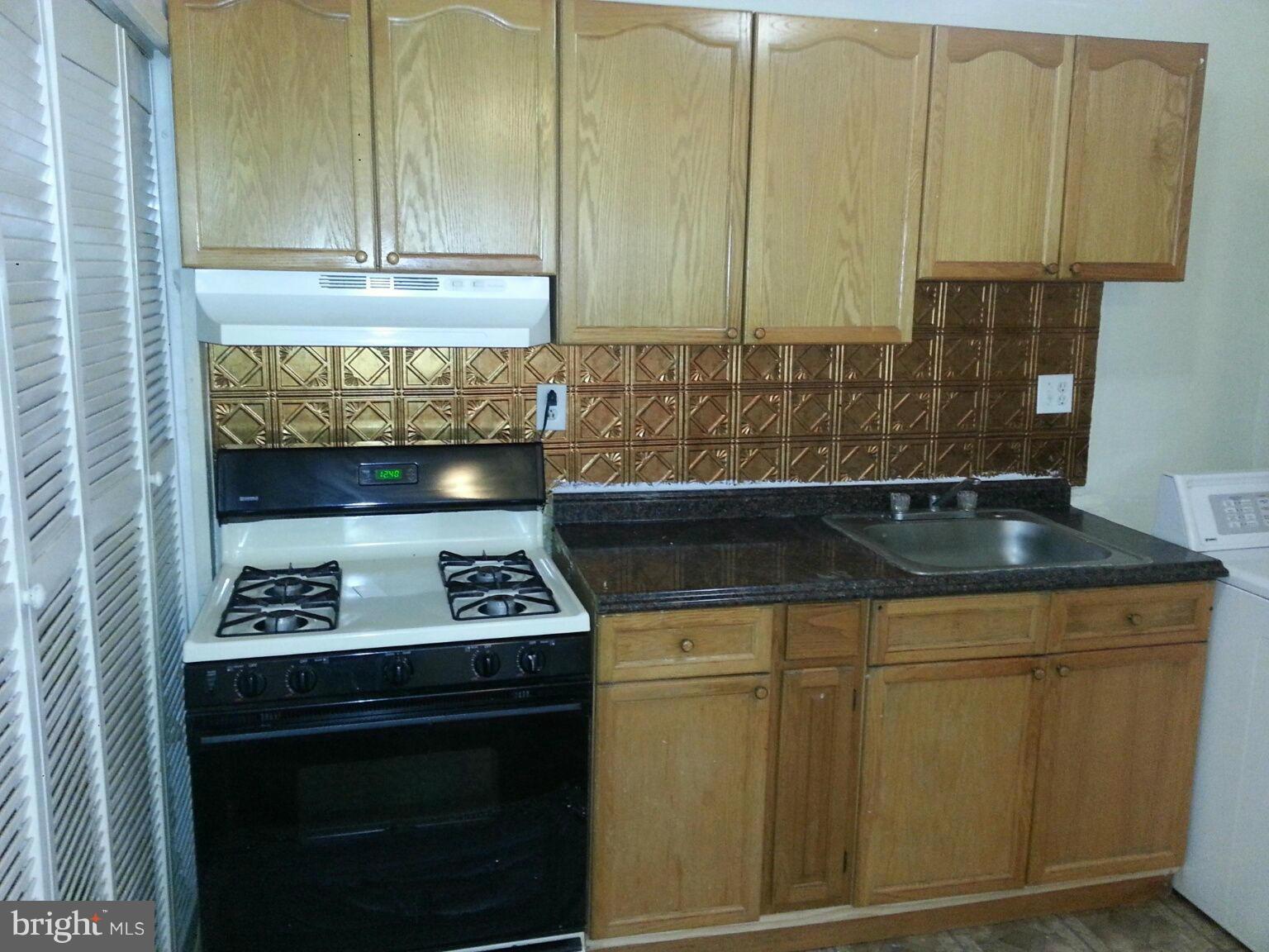 12130 Bluhill Road Silver Spring, MD 20902 - Photo 6 of 6 a kitchen with a stove and a cabinet