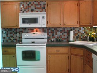 1328 Providence Road Secane, PA 19018 - Photo 6 of 12 a kitchen with stainless steel appliances granite countertop a stove and a microwave