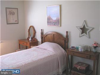 1328 Providence Road Secane, PA 19018 - Photo 9 of 12 a bedroom with a bed and a potted plant on the dresser