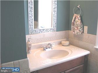 1328 Providence Road Secane, PA 19018 - Photo 10 of 12 a bath tub sitting in a bathroom next to a sink