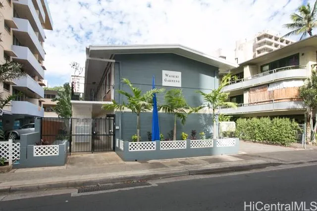 a view of a house with a yard and potted plants