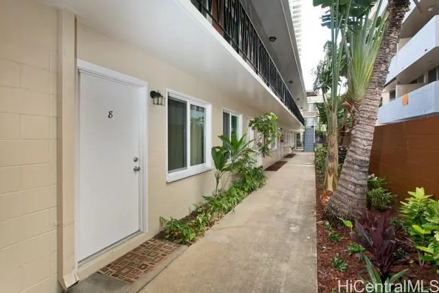 a view of a pathway with flower plants