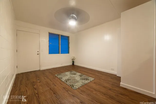 a view of a room with wooden floor and white walls