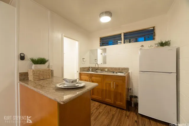a white refrigerator freezer sitting inside of a kitchen