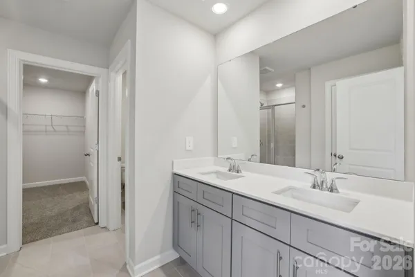 a bathroom with a sink double vanity and a mirror