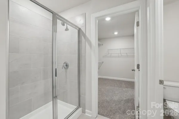 a bathroom with a shower and a glass door