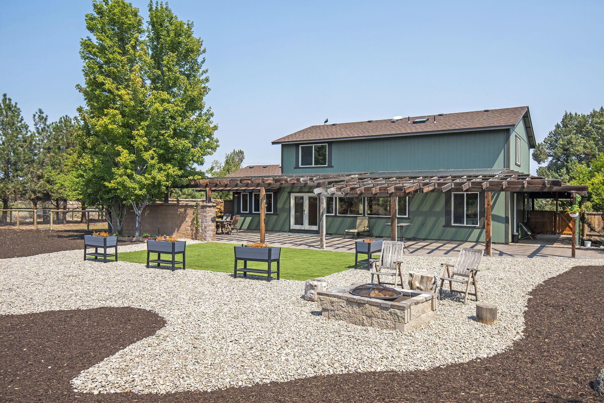66901 Lance Road Bend, OR 97703 - Photo 4 of 71 a view of a house with a yard patio and fire pit