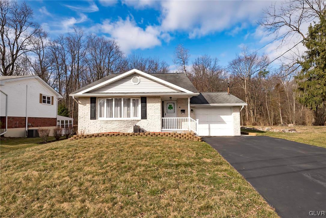 a front view of a house with a garden