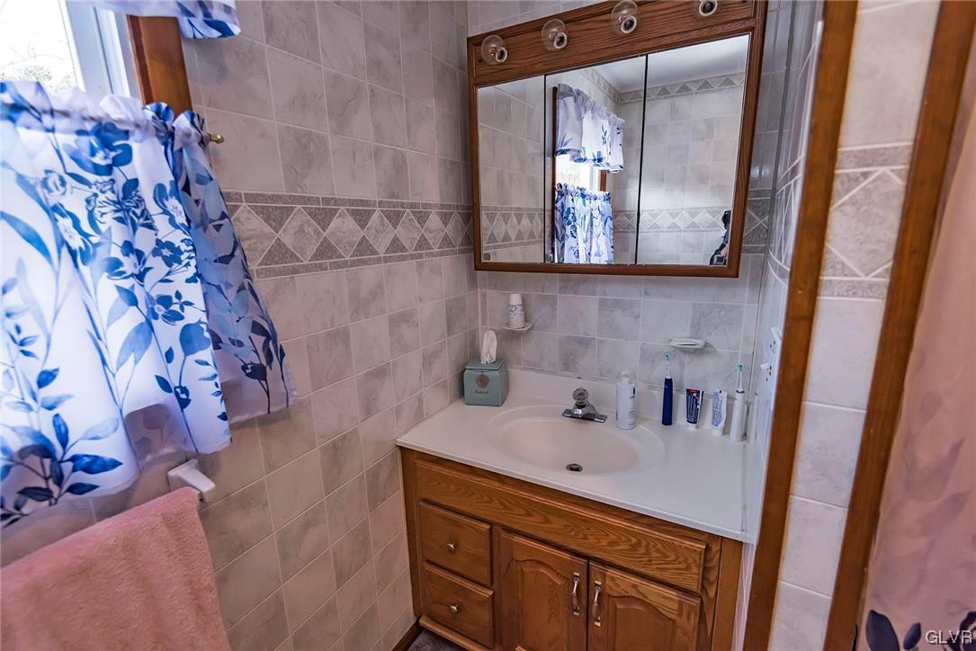 360 North 9th Street Bangor, PA 18013 - Photo 27 of 34 a bathroom with a sink mirror and vanity