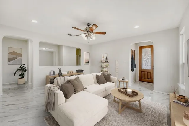 a living room with furniture and a chandelier