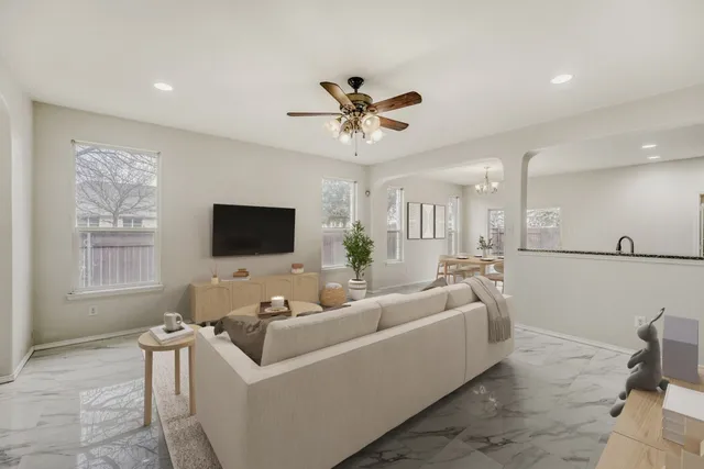 a living room with furniture a rug and a chandelier