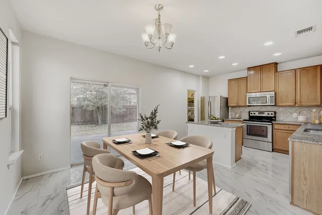 a open dining room with furniture and kitchen view