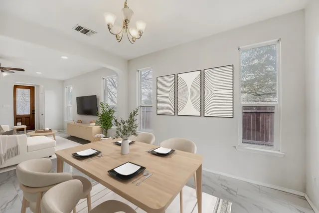 a kitchen with a dining table and chairs