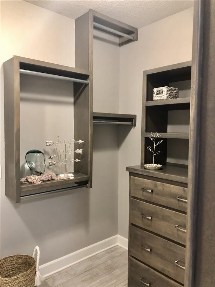 3913 North Solano Street Wichita, KS 67205 - Photo 18 of 25 Master closet with built in dresser and walk through one end to master bath and opposite end to laundry room