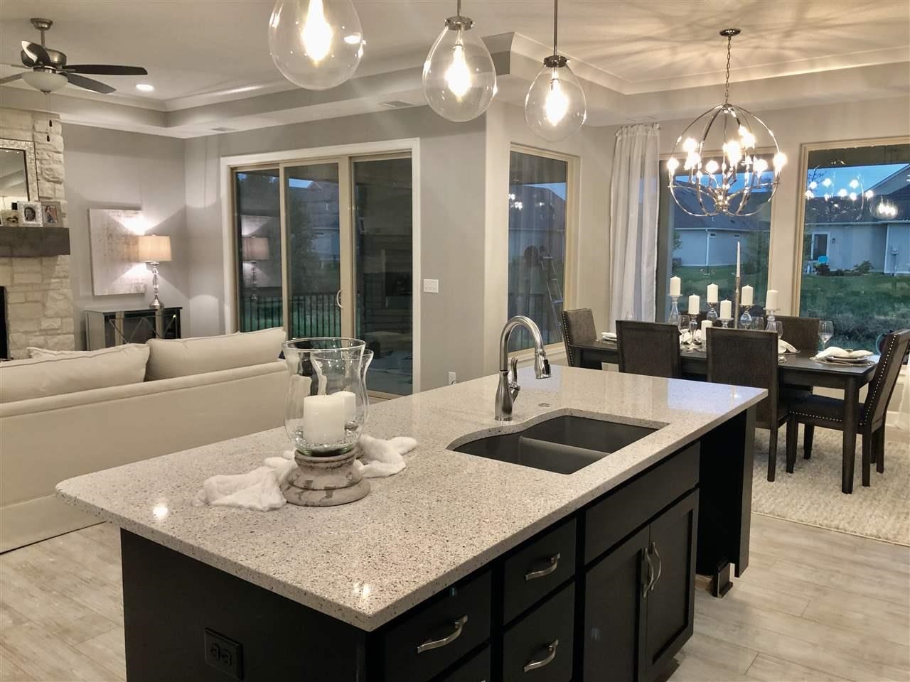 3913 North Solano Street Wichita, KS 67205 - Photo 4 of 25 Kitchen looking towards covered and screened patio with outdoor fireplace