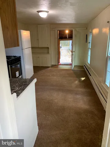 a kitchen with stainless steel appliances granite countertop a refrigerator a stove a sink and a microwave