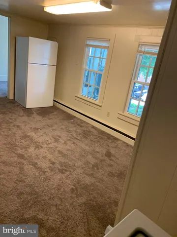 a view of a room with an empty space and a sink