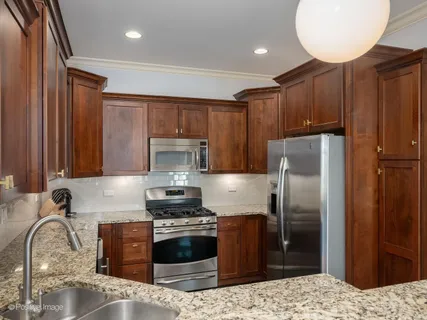 a kitchen with a refrigerator sink and stove