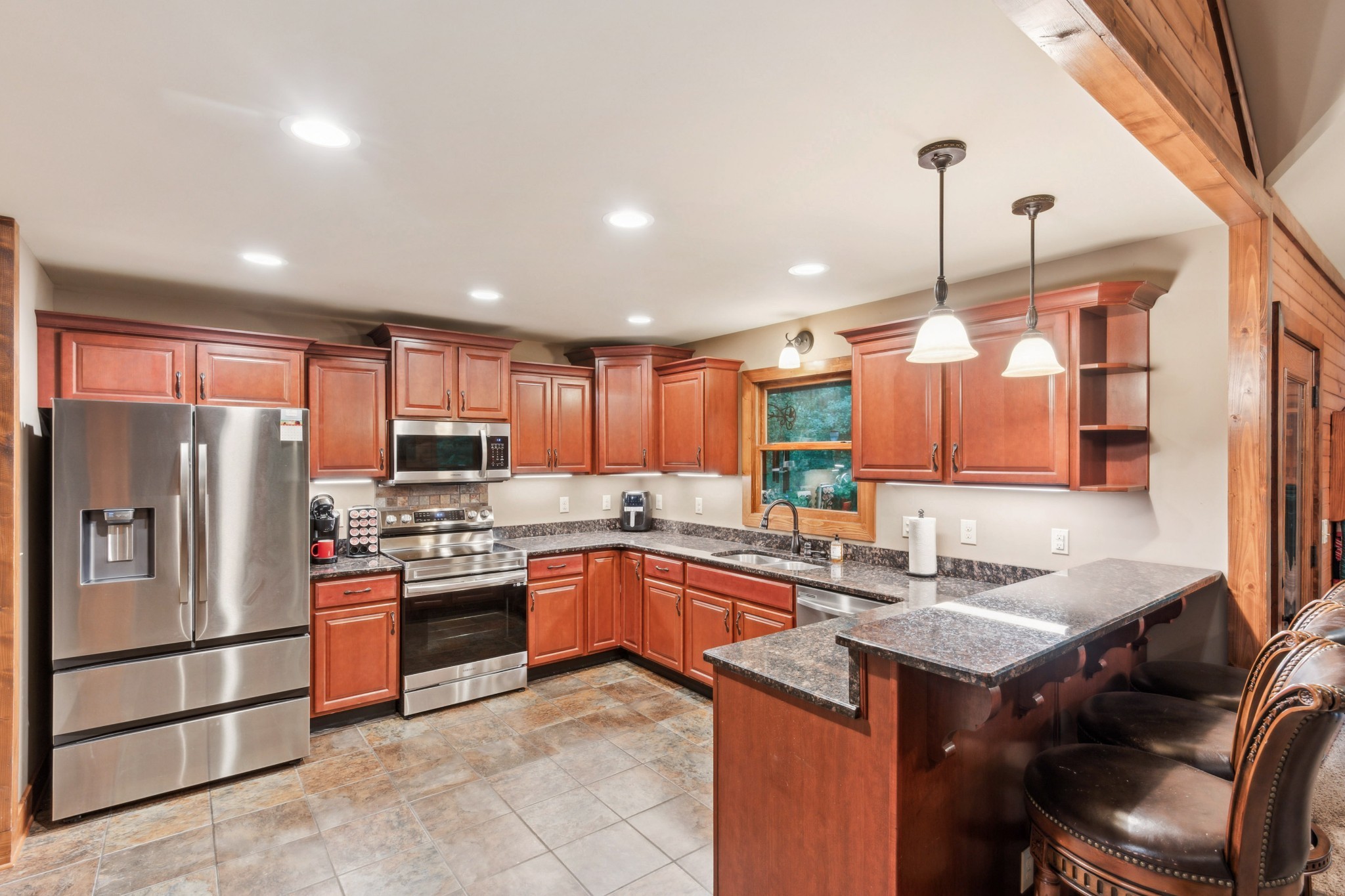 4455 Tarsus Road Palmyra, TN 37142 - Photo 18 of 38 a kitchen with stainless steel appliances granite countertop a sink a stove and a refrigerator