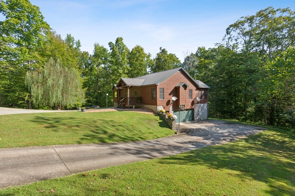 4455 Tarsus Road Palmyra, TN 37142 - Photo 2 of 38 a front view of a house with a yard and trees