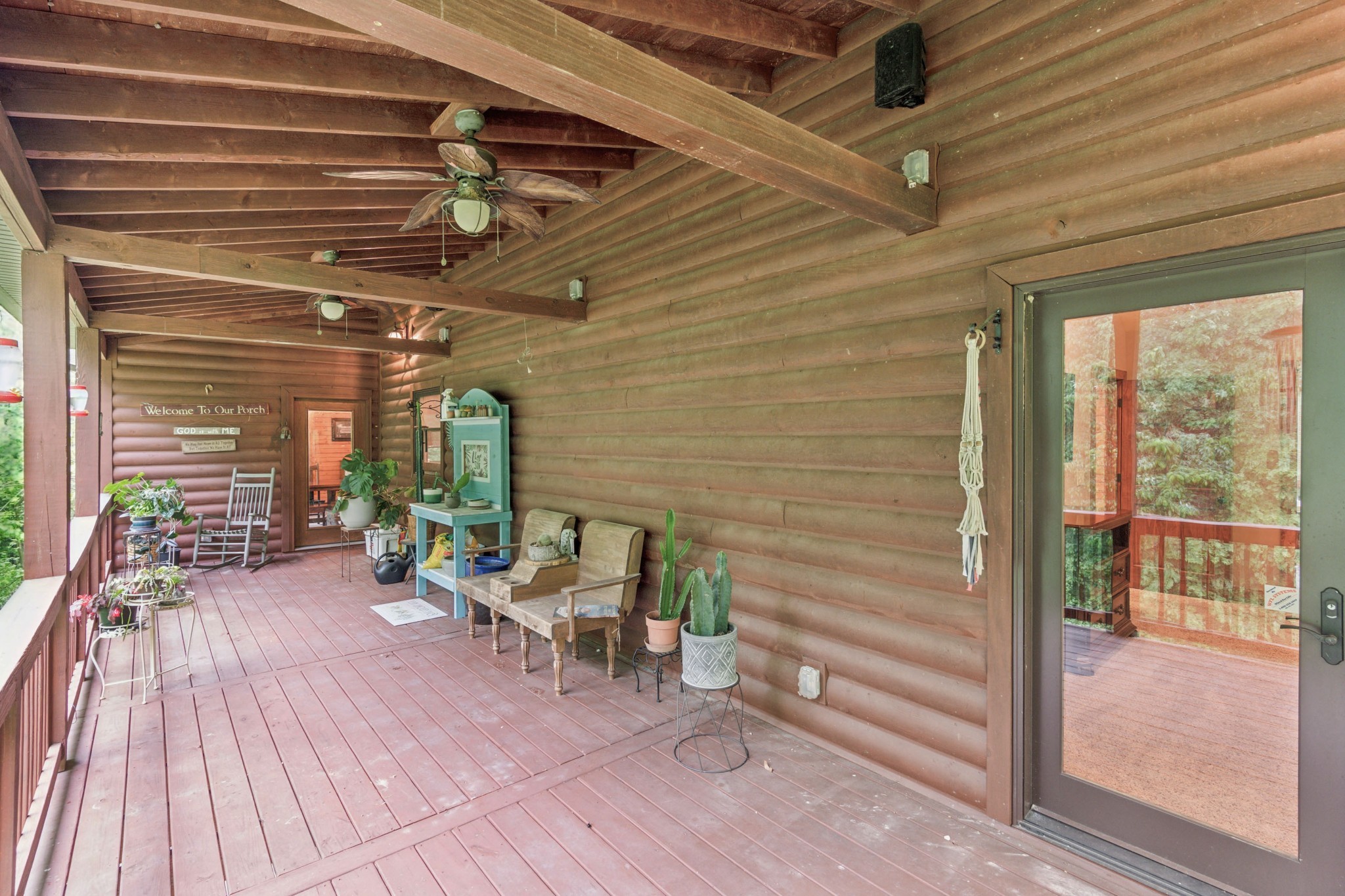 4455 Tarsus Road Palmyra, TN 37142 - Photo 33 of 38 a view of a patio with table and chairs potted plants with wooden floor and floor to ceiling window