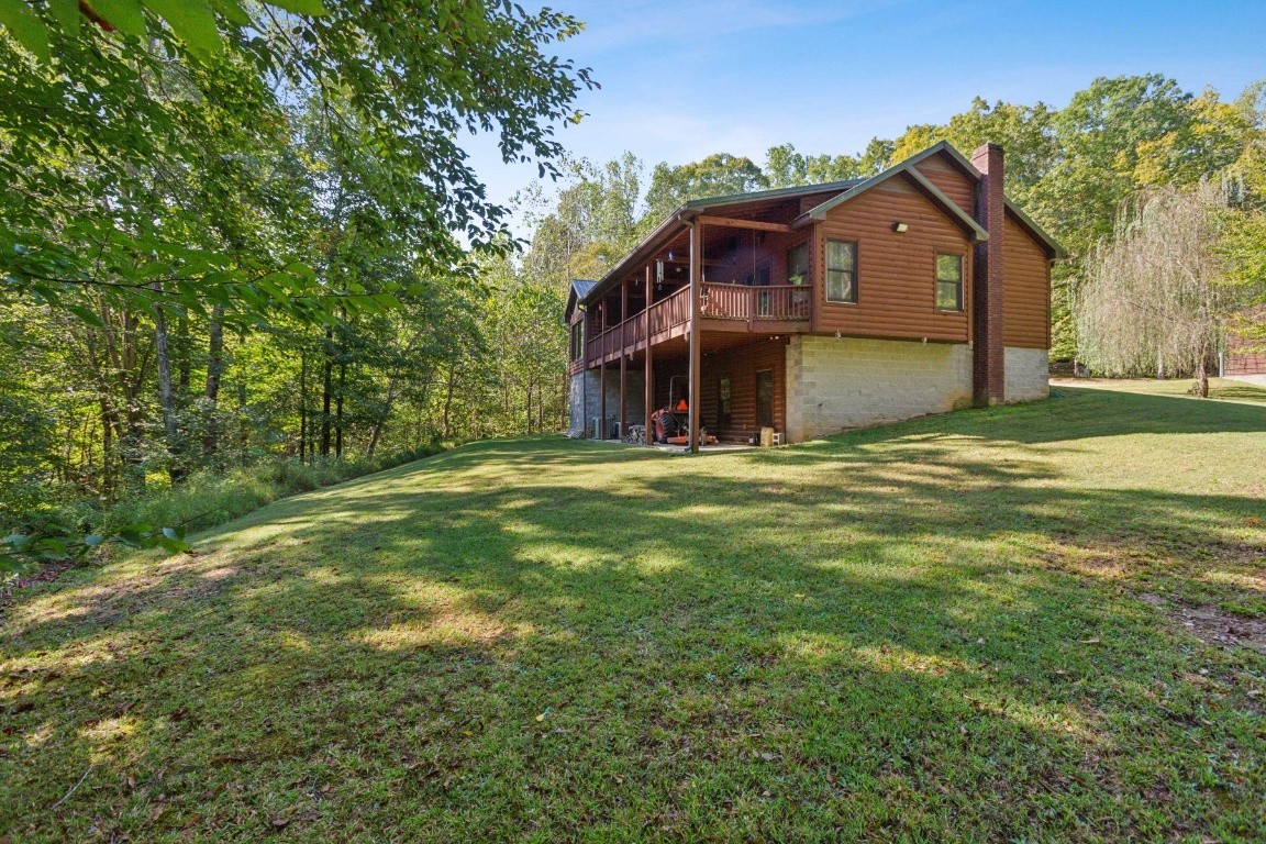 4455 Tarsus Road Palmyra, TN 37142 - Photo 10 of 38 a view of a house with a big yard and large trees
