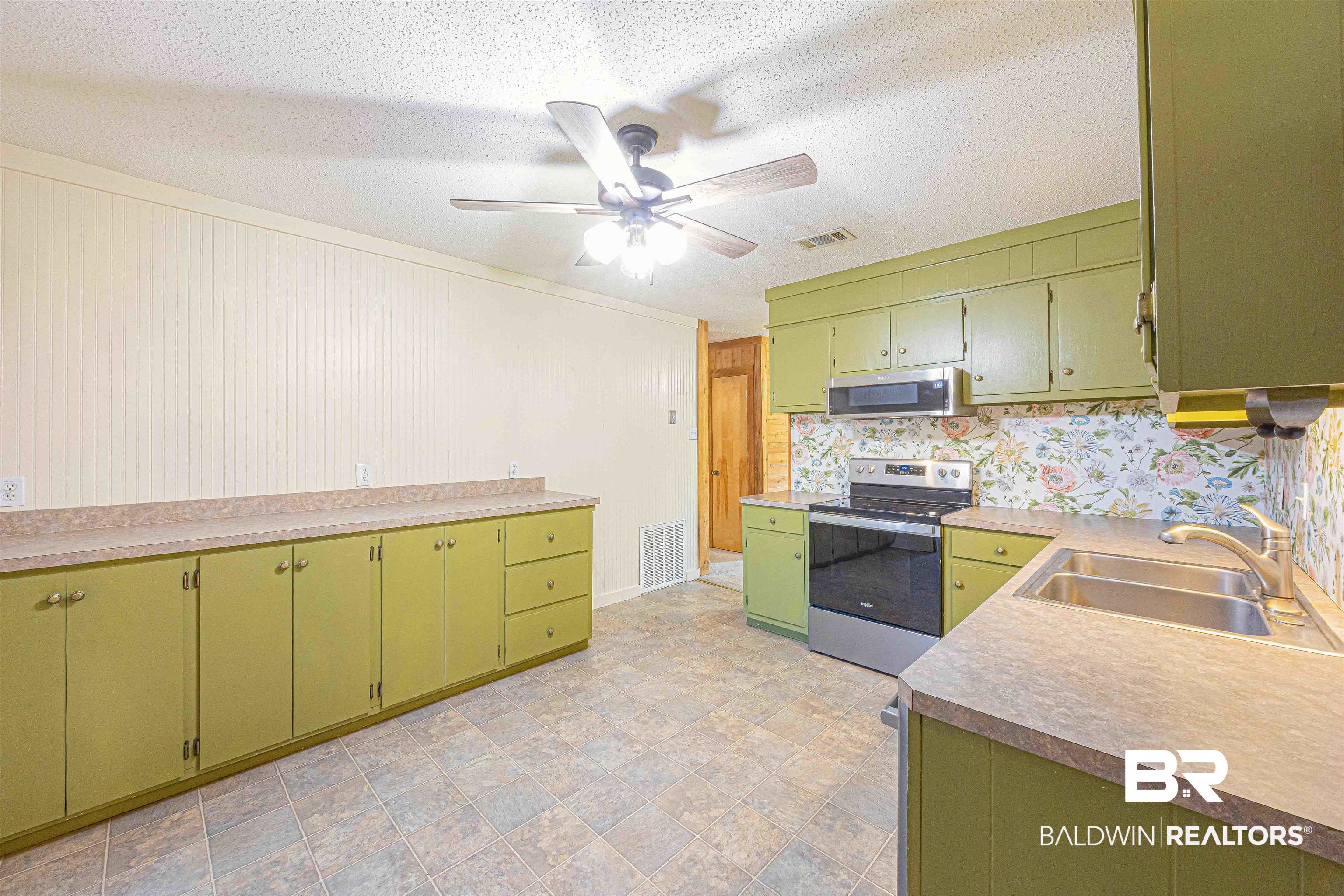 43101 Brown Road Bay Minette, AL 36507 - Photo 16 of 81 Kitchen with stainless steel appliances, green cabinetry, wallpapered walls, a textured ceiling, and a ceiling fan