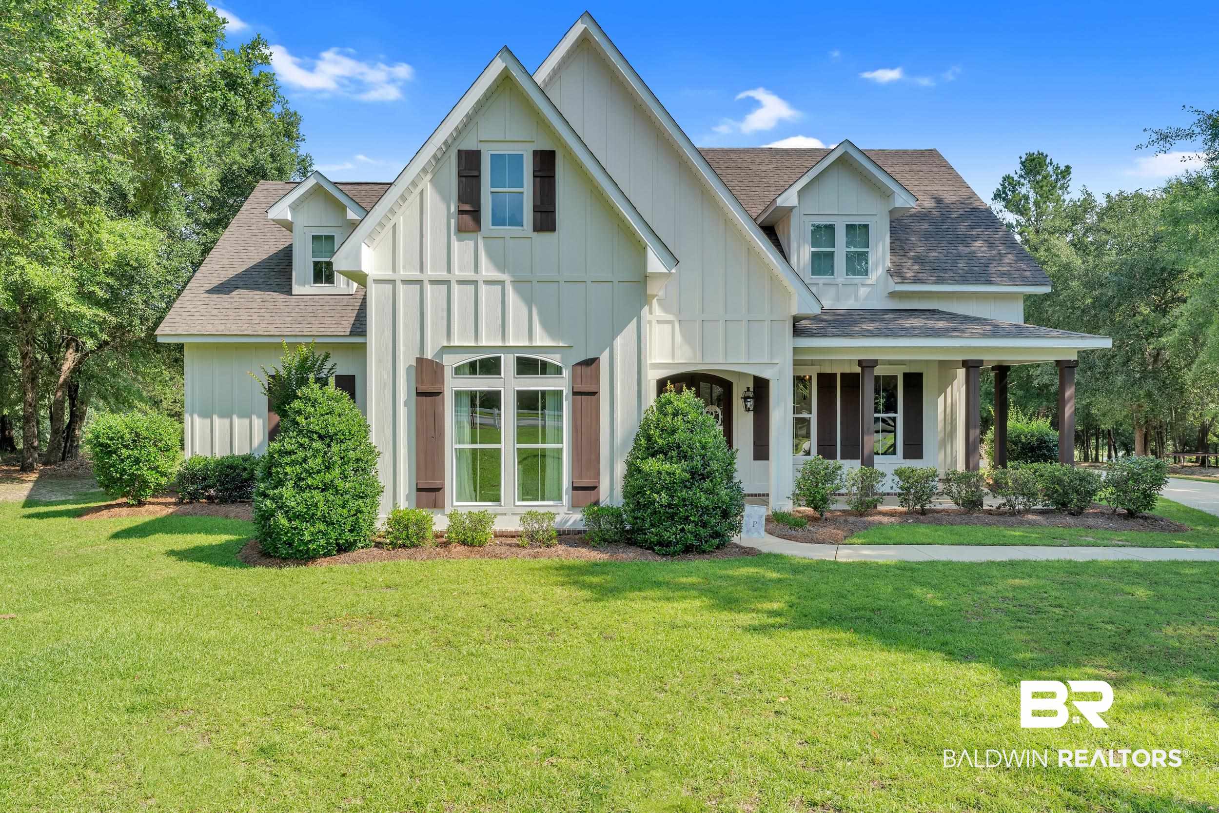 14531 Styx River Road Stapleton, AL 36578 - Photo 1 of 50 View of front of property featuring board and batten siding, roof with shingles, and a front lawn