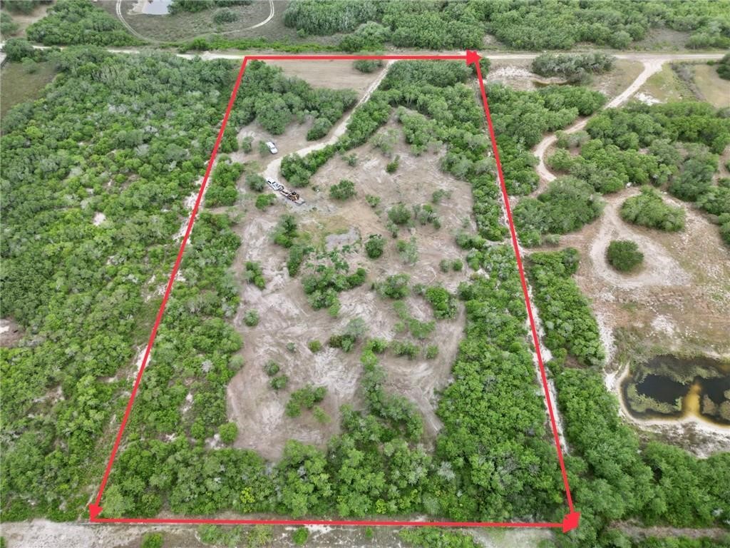 0 West Rhodes Avenue Aransas Pass, TX 78336 - Photo 7 of 11 an aerial view of residential house with outdoor space and trees all around