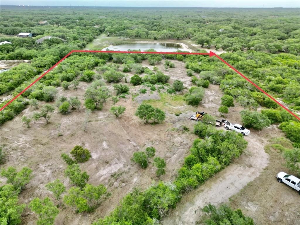 0 West Rhodes Avenue Aransas Pass, TX 78336 - Photo 8 of 11 an aerial view of residential houses with outdoor space and trees